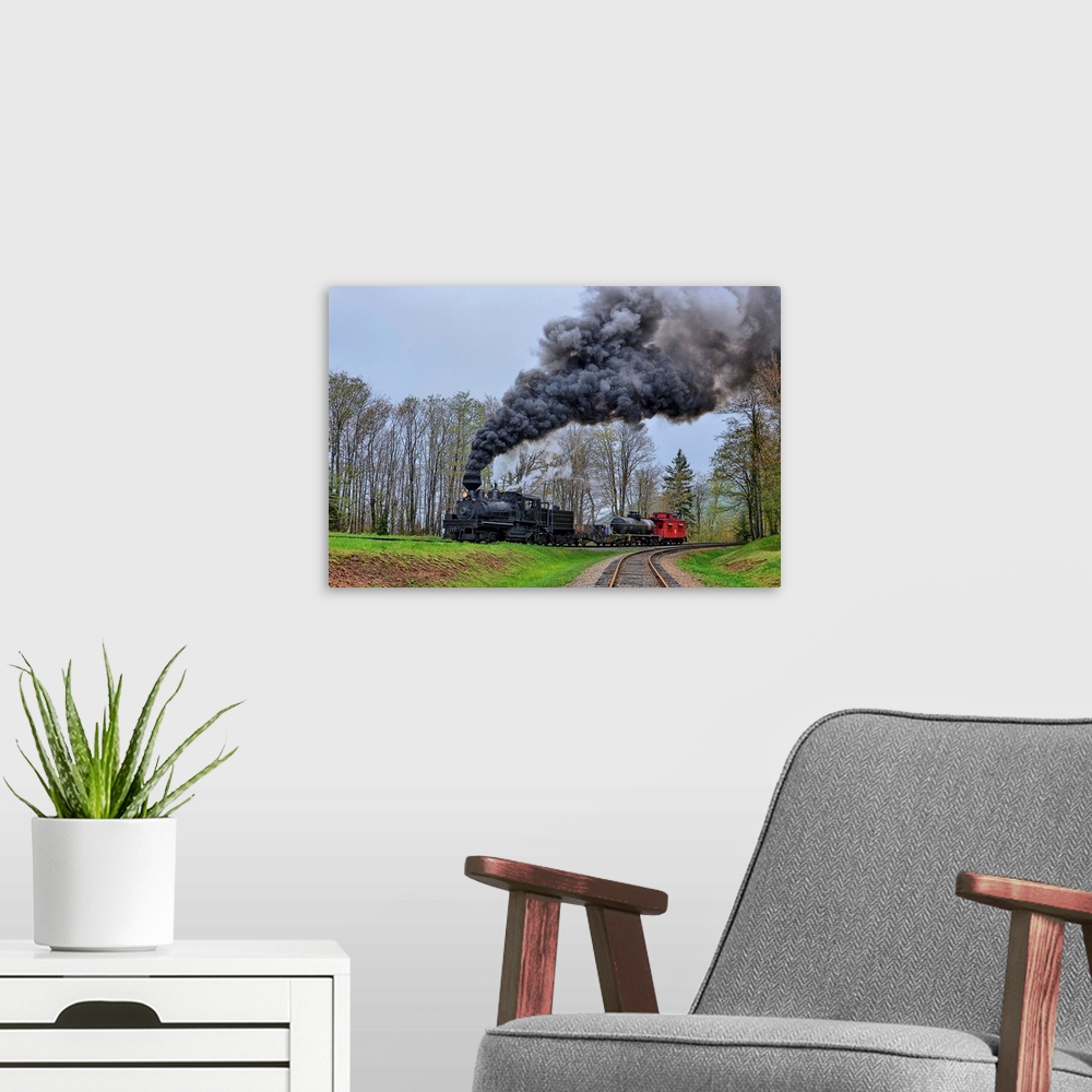 A modern room featuring A locomotive with billowing black smoke climbs up a hill.