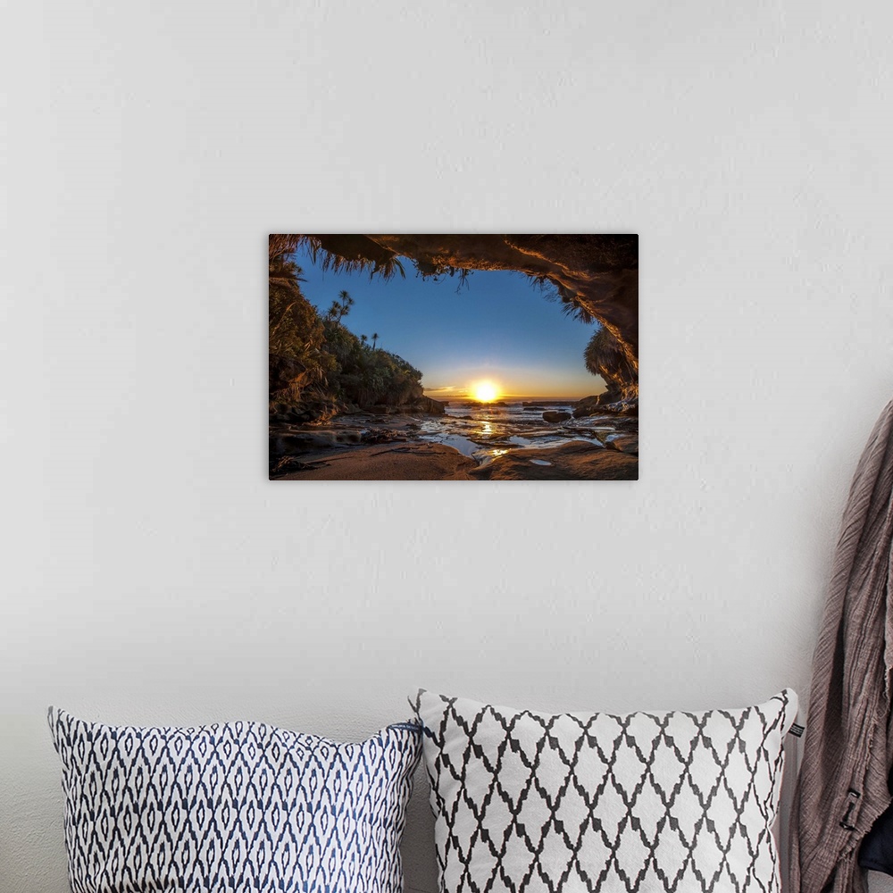 A bohemian room featuring Sunset on the ocean from a cave on the New Zealand coast.