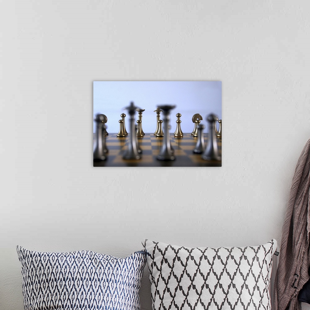 A bohemian room featuring Rows of chessmen on a board.