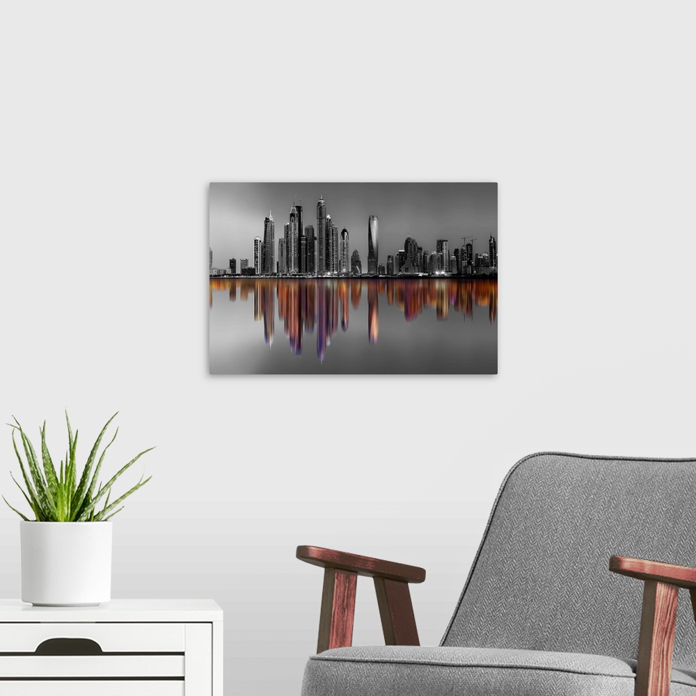 A modern room featuring Black and white image of hte Marina Towers in Dubai, with a reflection in color.