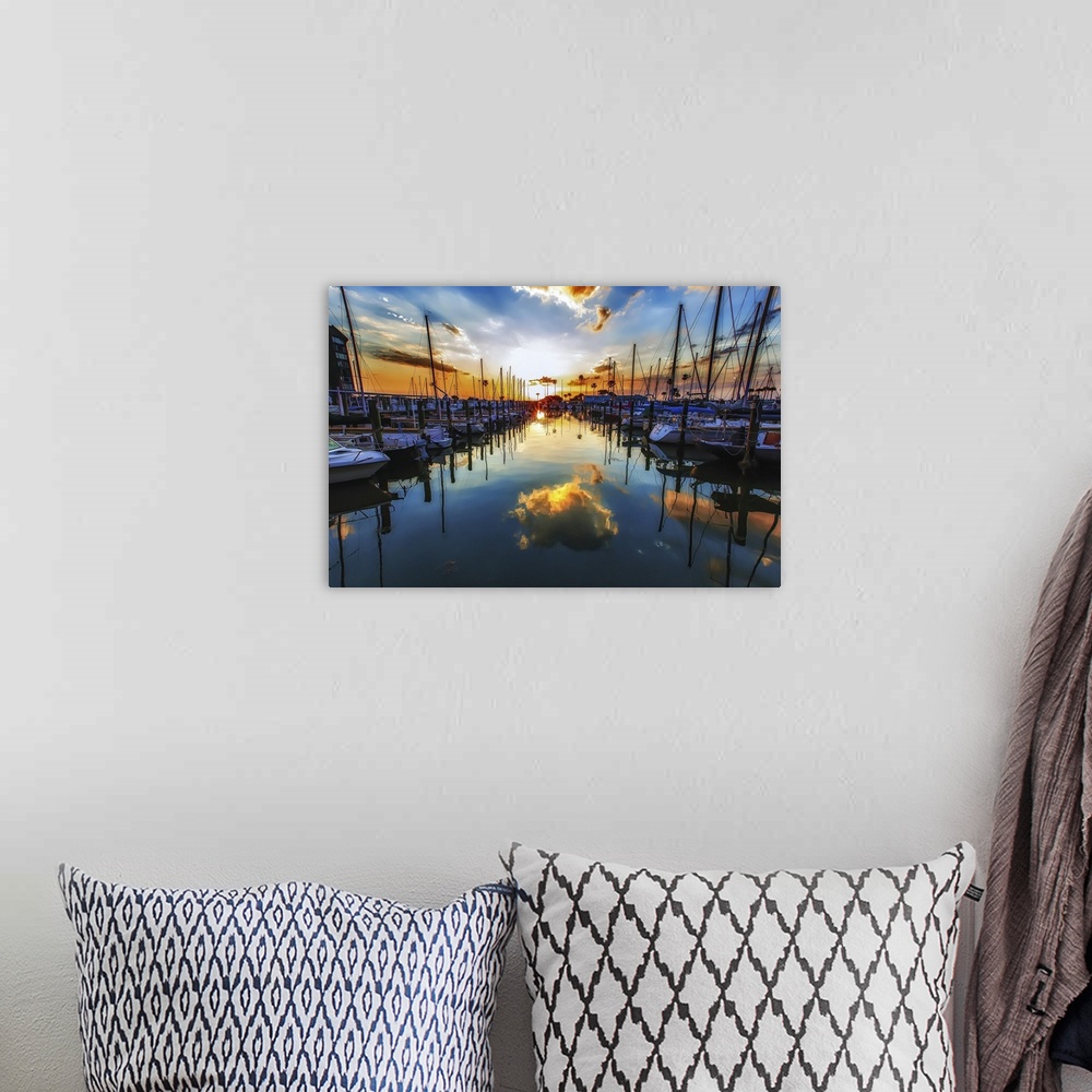 A bohemian room featuring Sailboats in a harbor casting perfect reflections in the water below.