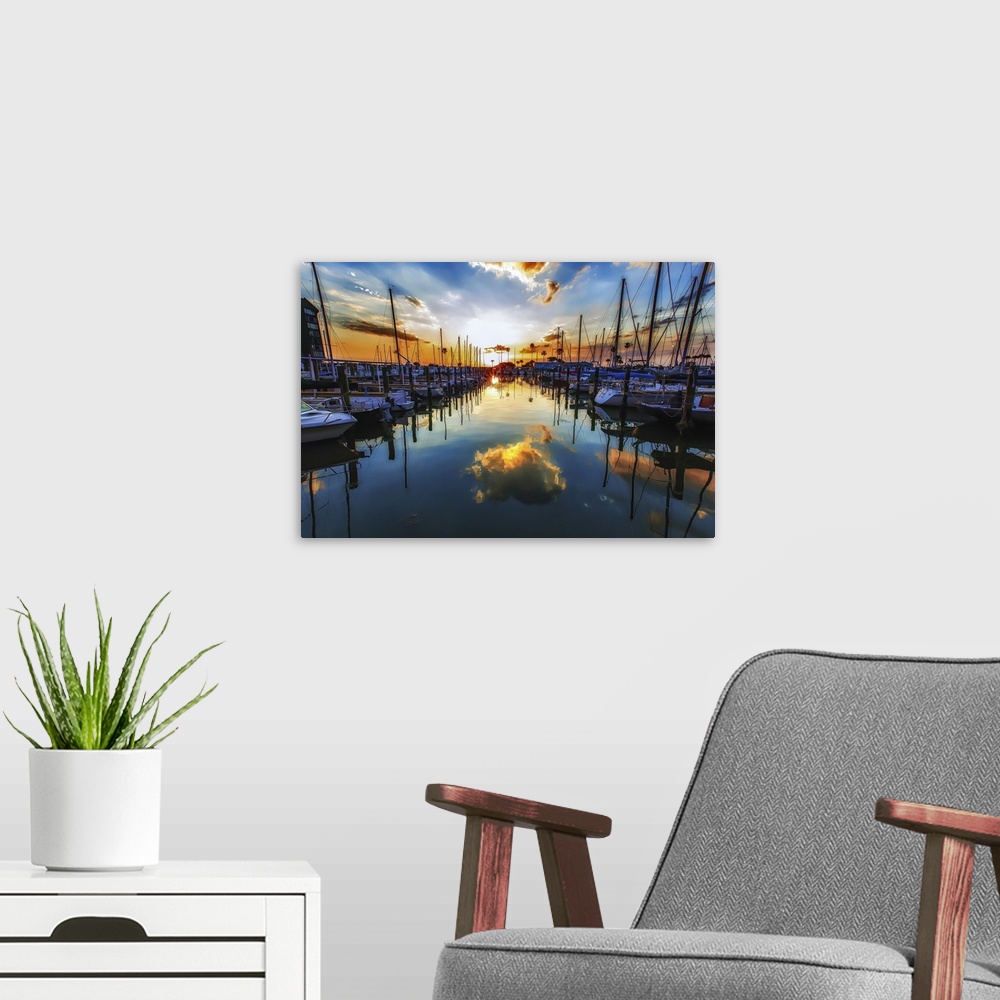 A modern room featuring Sailboats in a harbor casting perfect reflections in the water below.