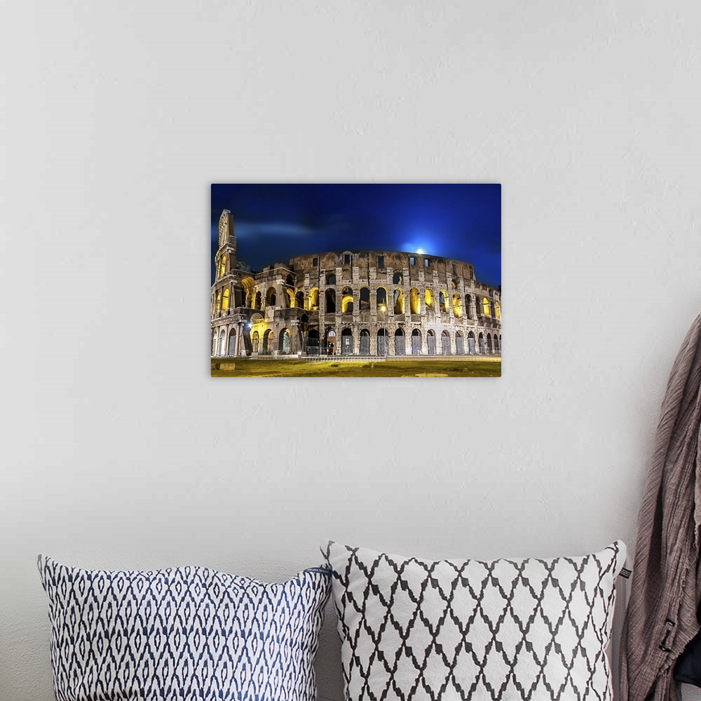 A bohemian room featuring The Colosseum in Rome lit up at night.