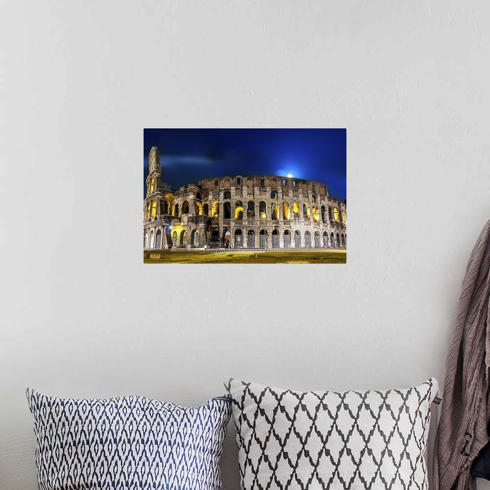 A bohemian room featuring The Colosseum in Rome lit up at night.