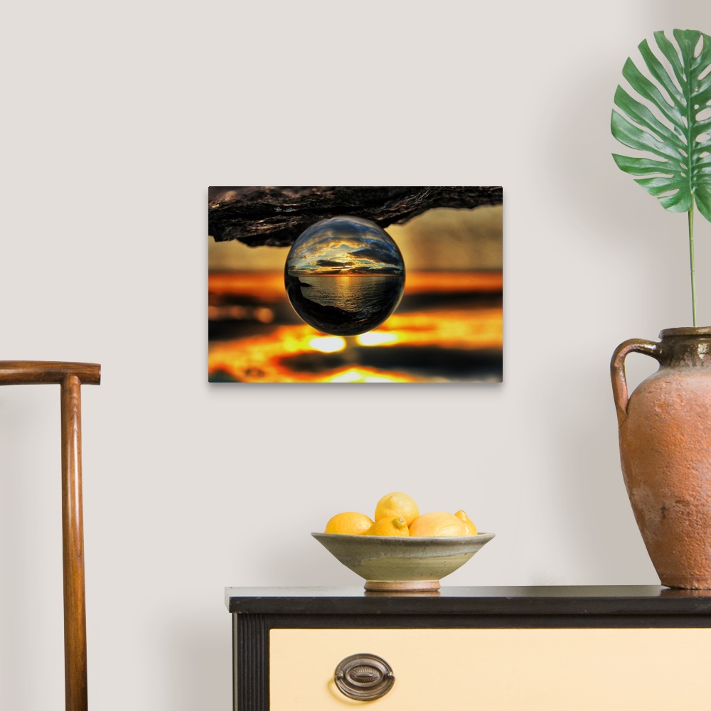 A traditional room featuring A sunset seascape reflected right-side-up in an upsidedown glass ball.