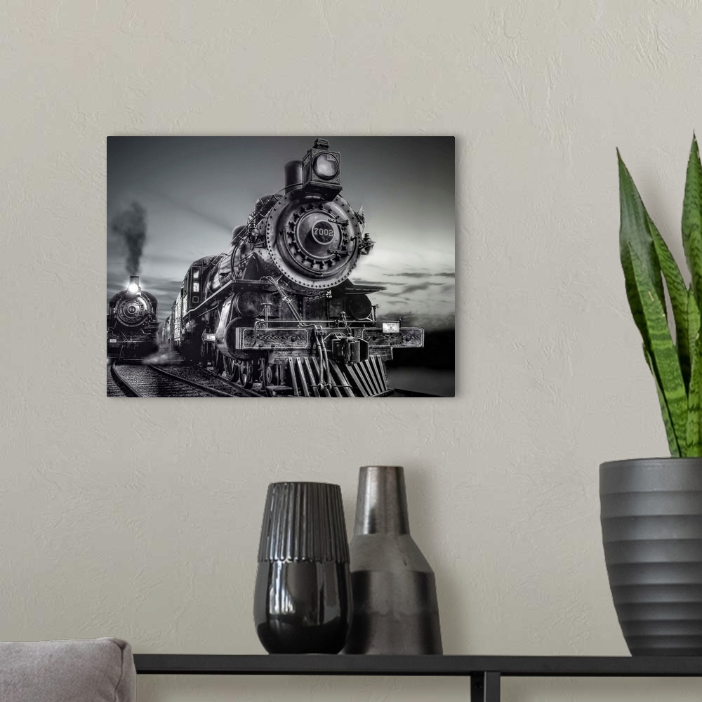 A modern room featuring Black and white photograph of trains on a railroad together.