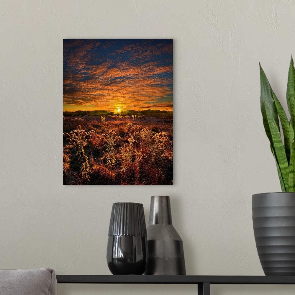 A modern room featuring Golden sunset and brilliant clouds over a field of farmland.