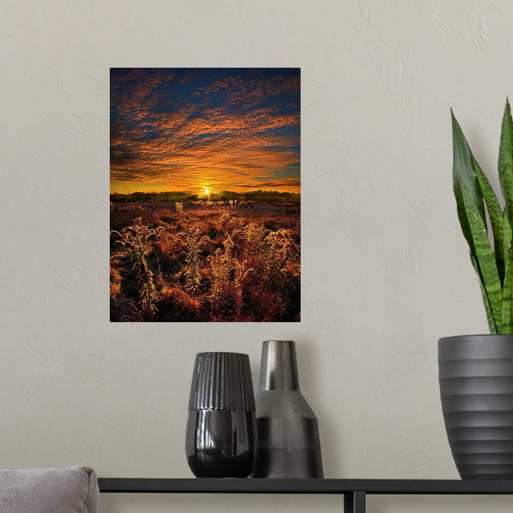 A modern room featuring Golden sunset and brilliant clouds over a field of farmland.