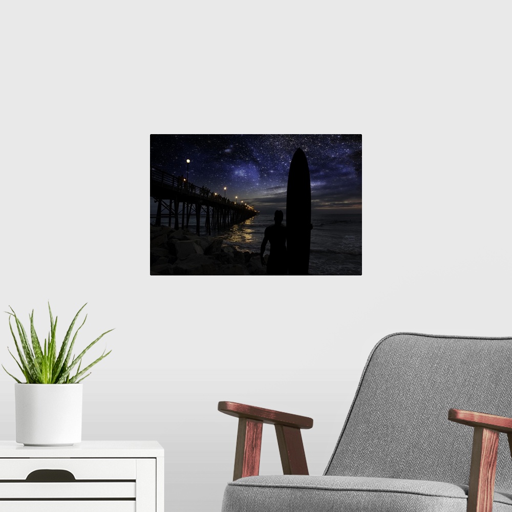 A modern room featuring A silhouetted long board surfer watches the stars and dreams of big waves near the Oceanside Pier...