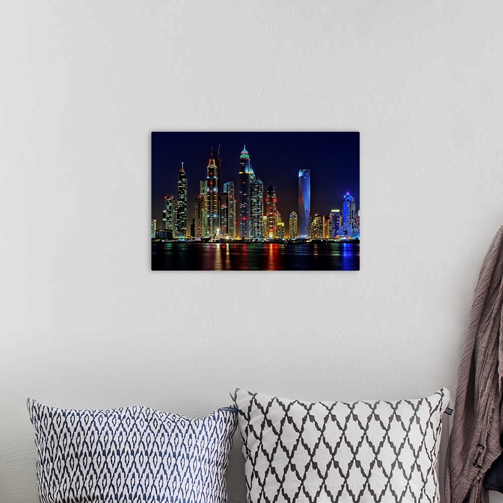 A bohemian room featuring Dubai skyline at night lit up in neon lights.