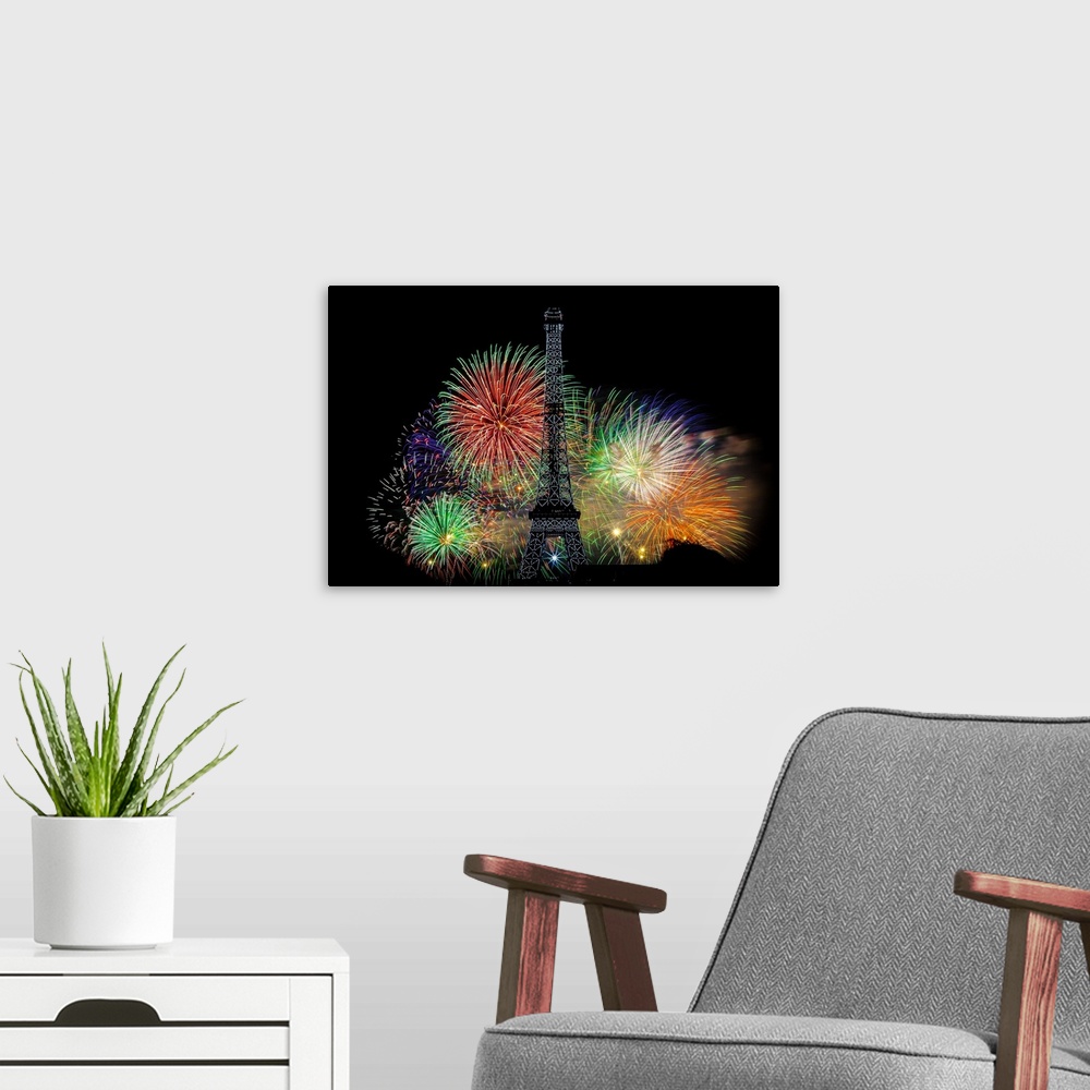 A modern room featuring Fireworks exploding in the air behind the Eiffel Tower in Paris.