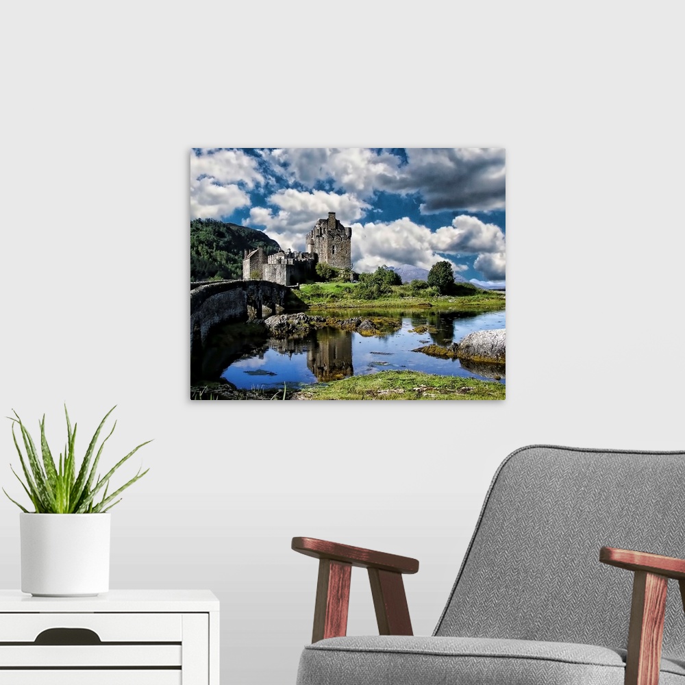 A modern room featuring A river and Eilan Donan Castle, Scotland, under a cloudy sky.