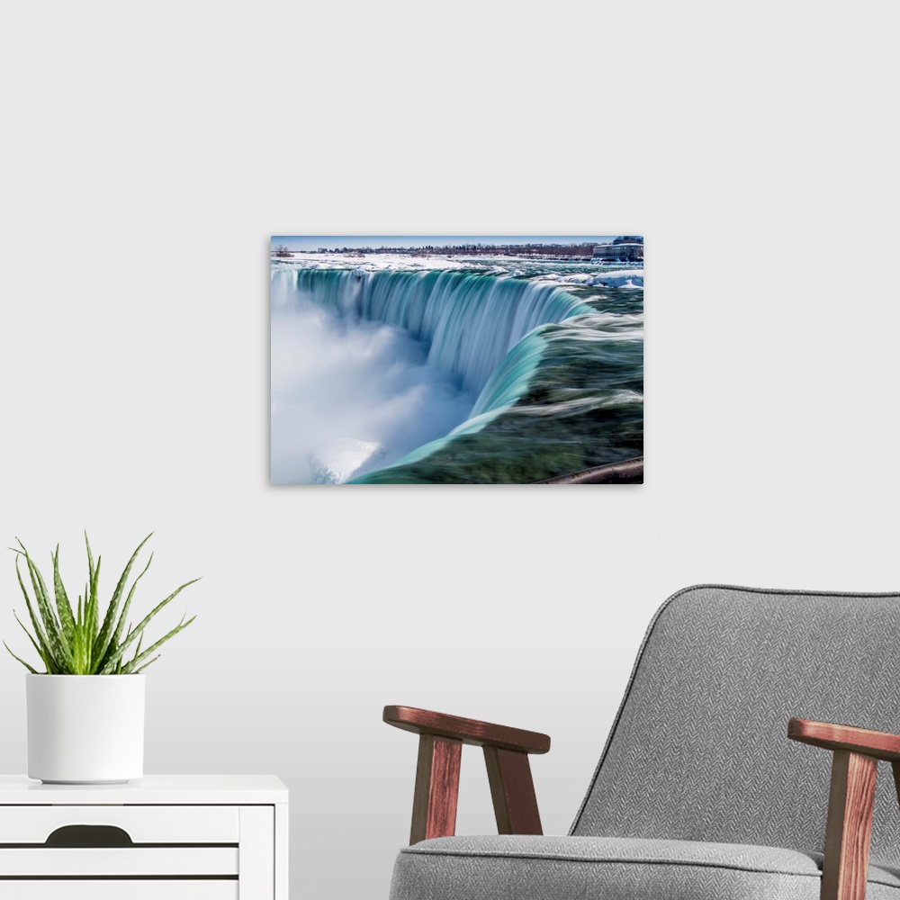 A modern room featuring The impressive Niagara Falls in February.