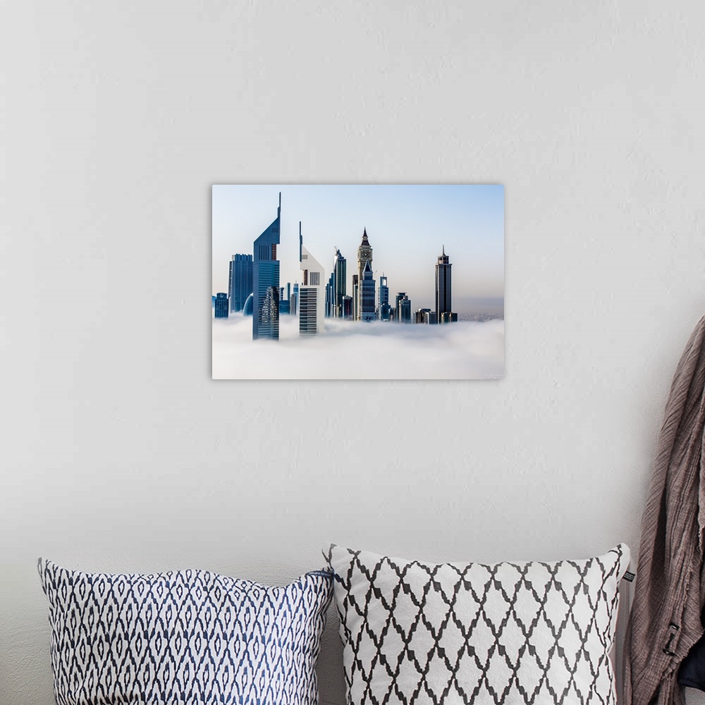 A bohemian room featuring Jumeirah Emirates Towers stand tall in the fog with the Arabian Gulf in the background.