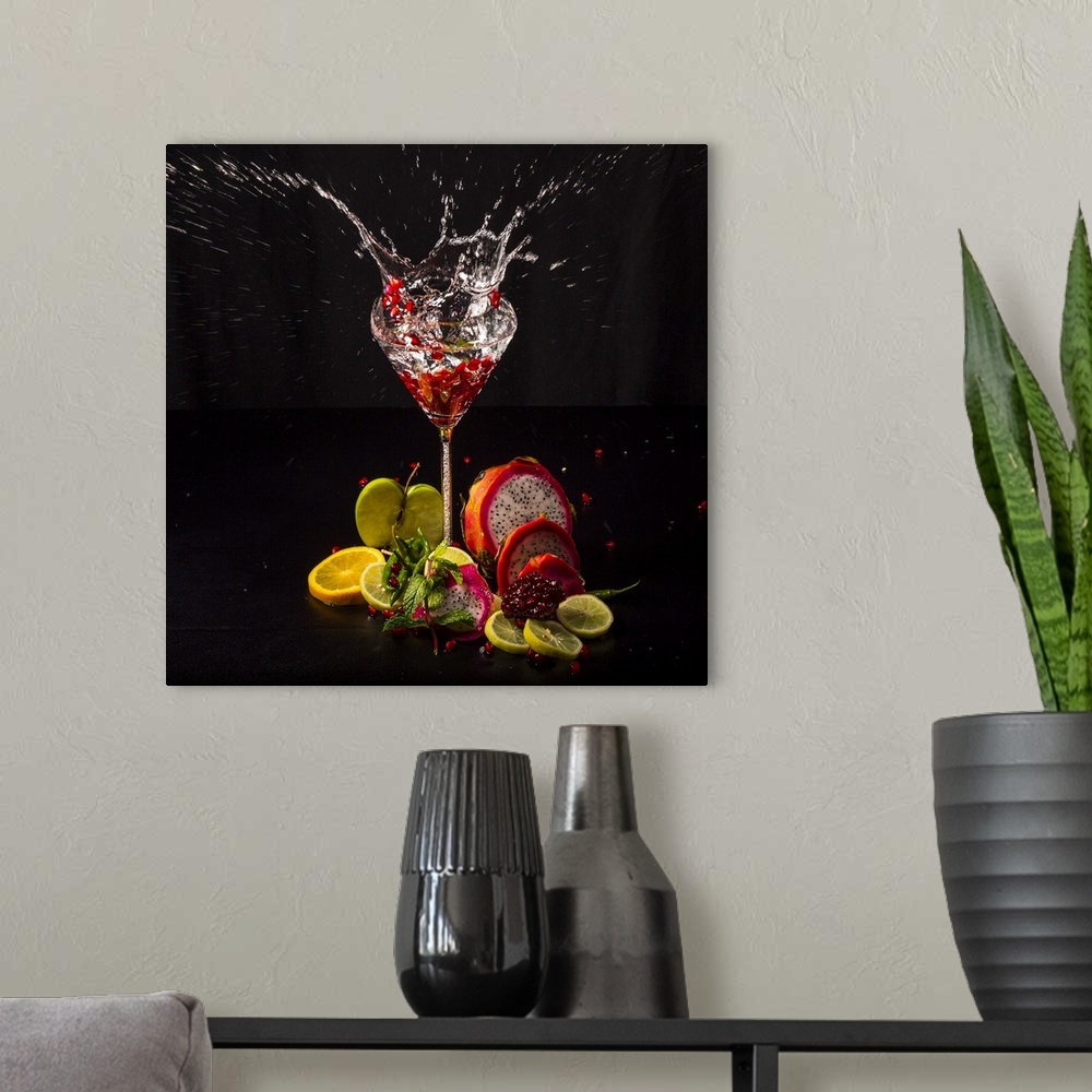 A modern room featuring Fruit splashing into a glass of liquid.