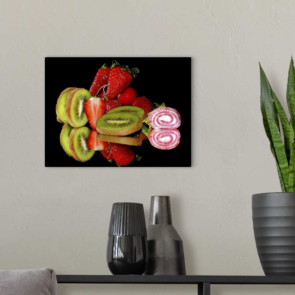 A modern room featuring Kiwis, strawberries, and candy on a mirror.