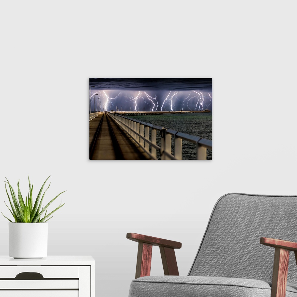 A modern room featuring Busselton Jetty, Western Australia, during an intense lightning storm.