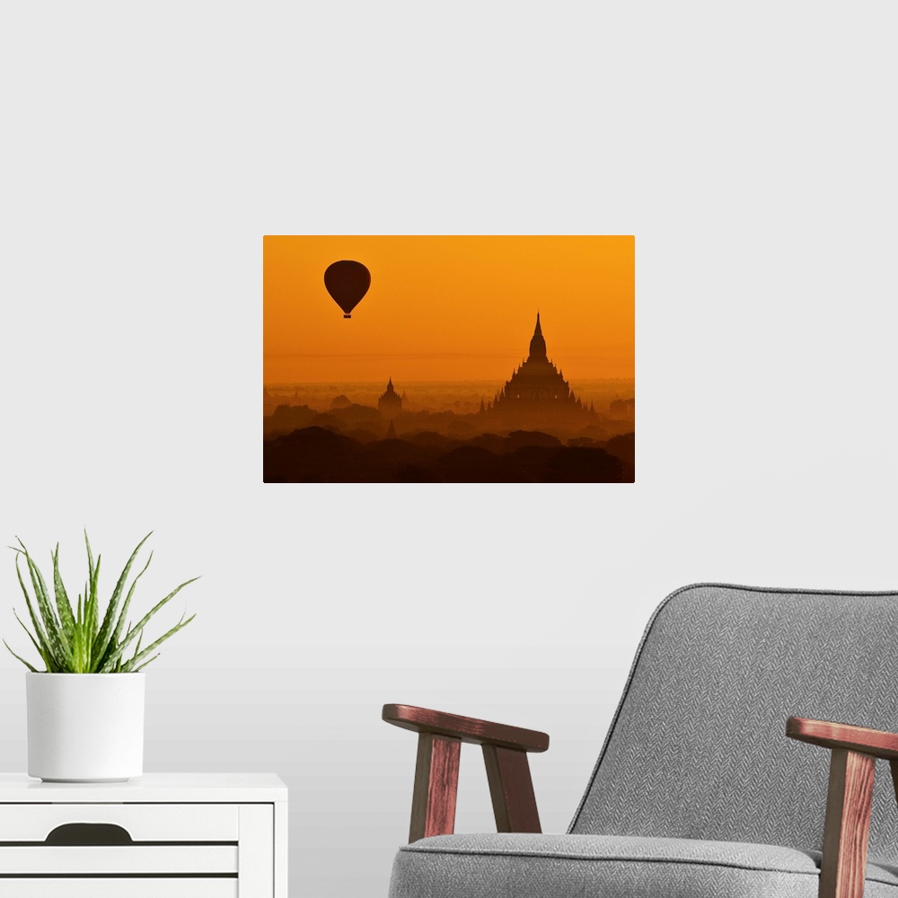 A modern room featuring Silhouette of a balloon over temples in the morning in Bagan, Myanmar