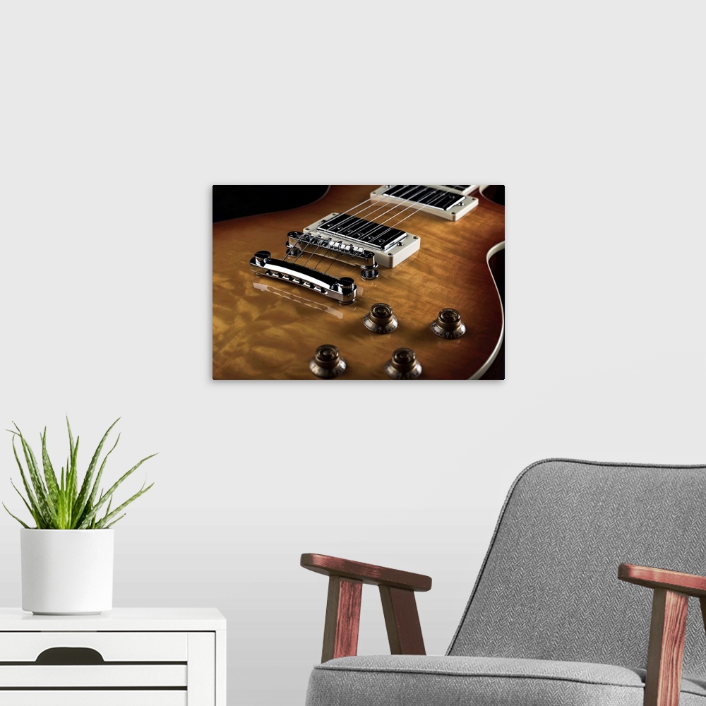 A modern room featuring Close up of an electric guitar.