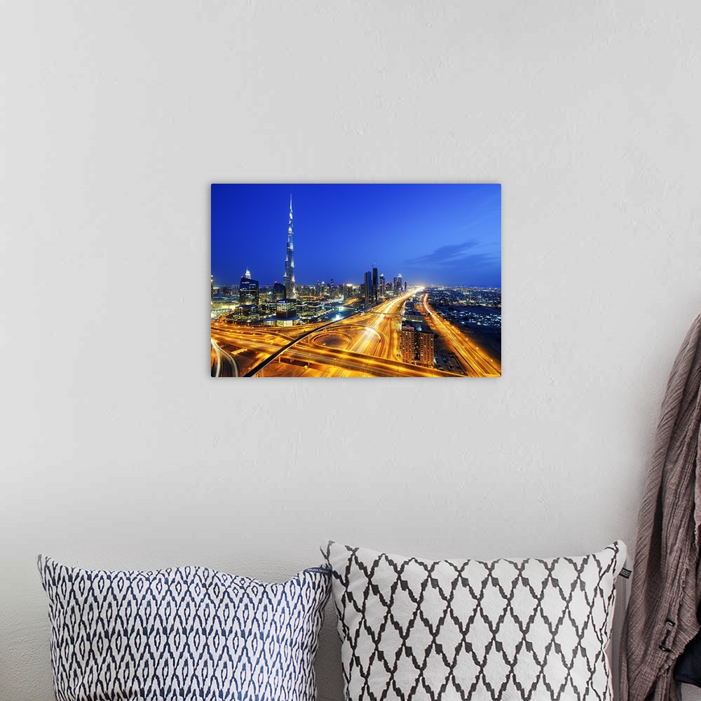 A bohemian room featuring Aerial photograph of Dubai city skyline at night, with light trails filling the city streets below.