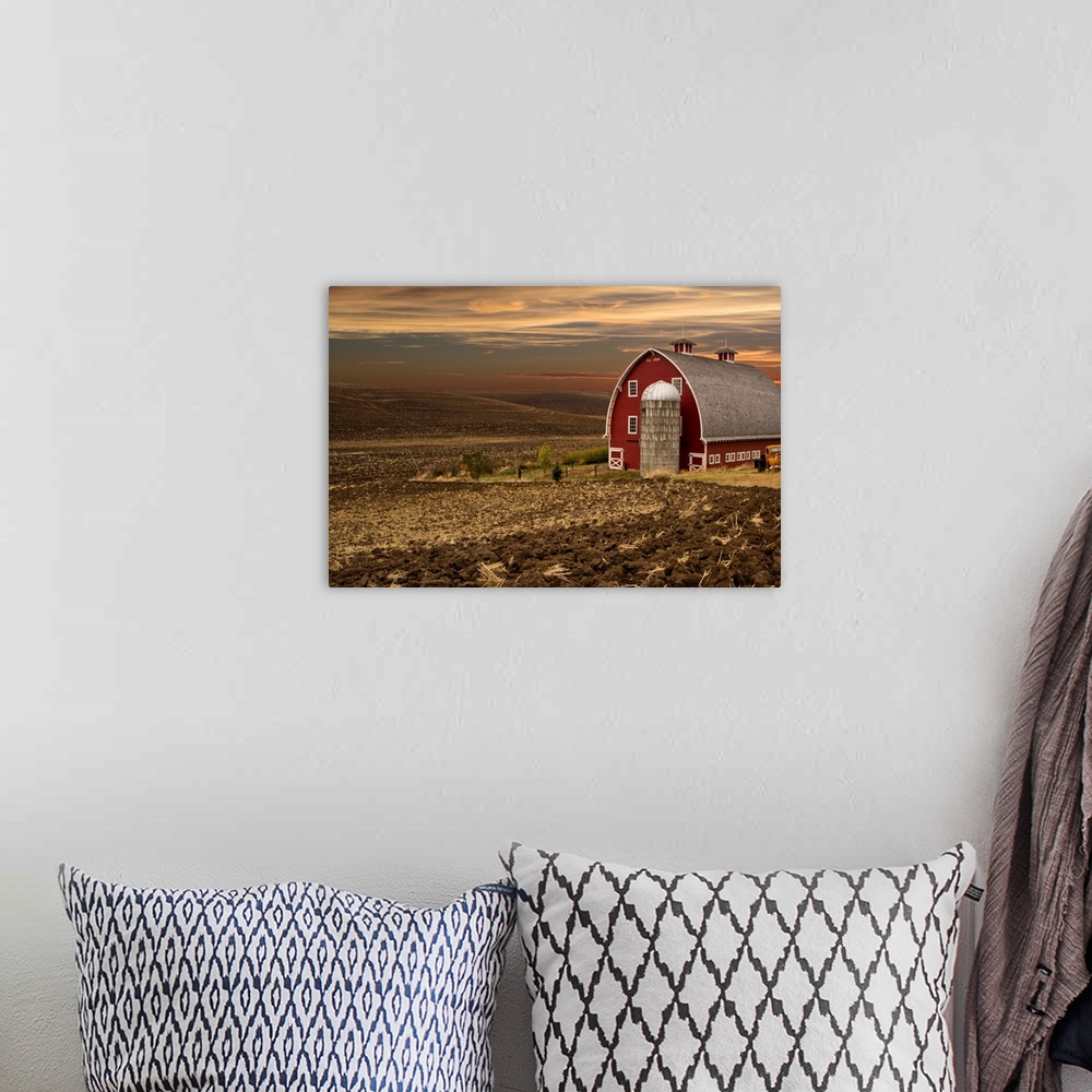 A bohemian room featuring Large red barn at sunset, Palouse, Washington.