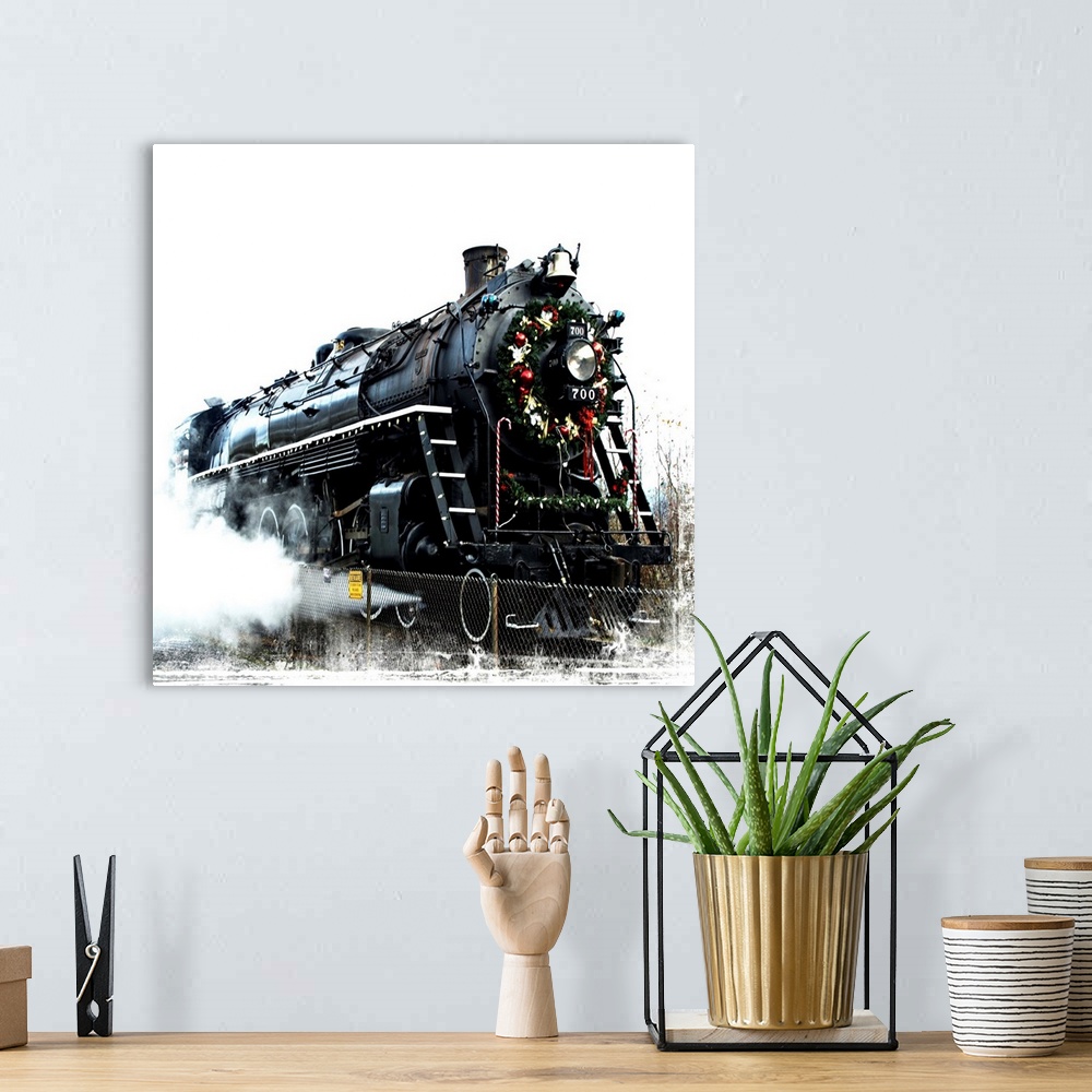 A bohemian room featuring A black locomotive with a festive wreath on its nose.