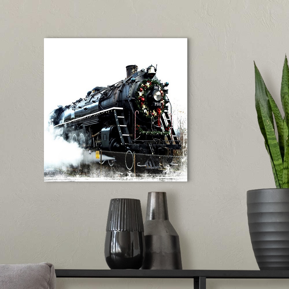A modern room featuring A black locomotive with a festive wreath on its nose.