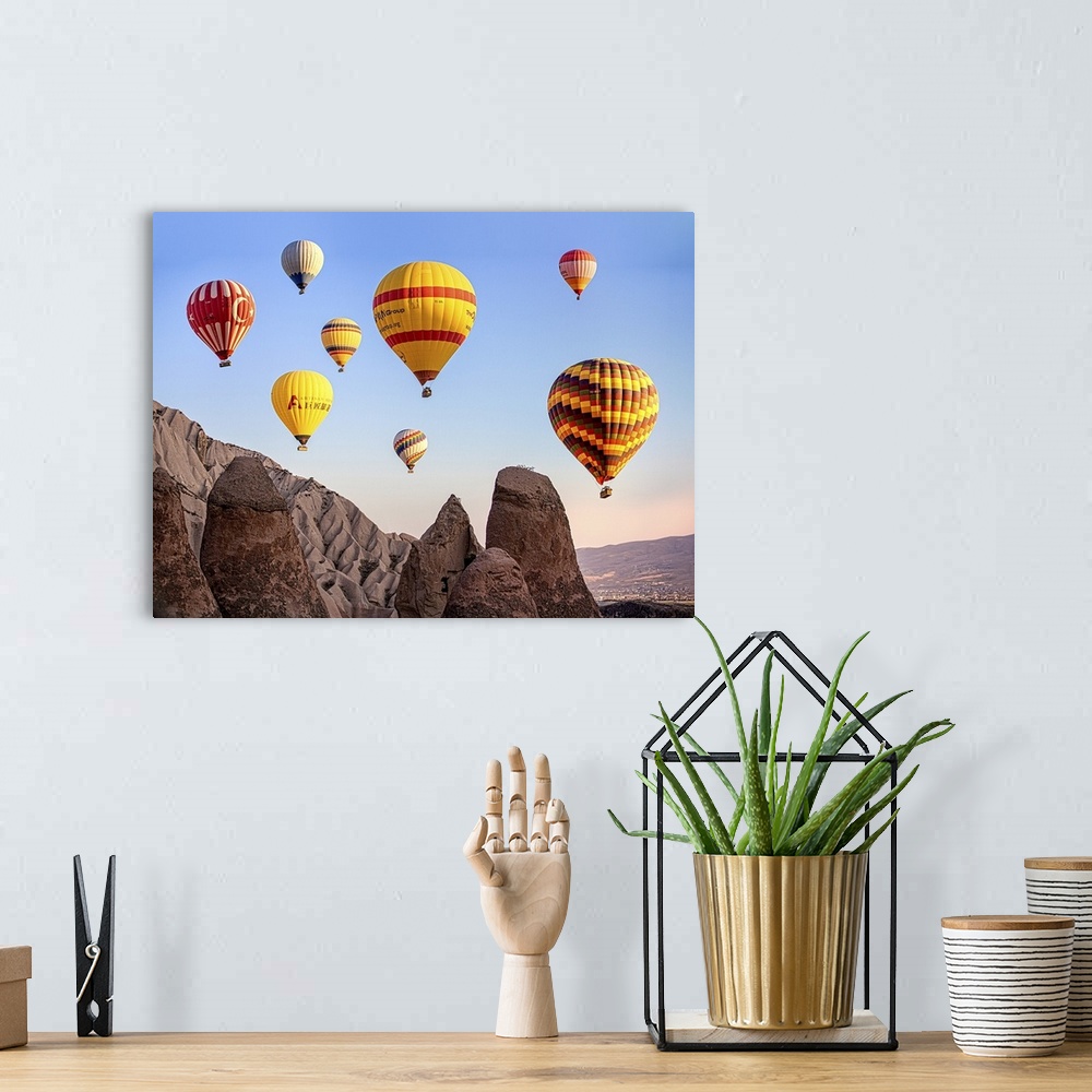 A bohemian room featuring Large, colorful hot air balloons floating in the sky over Cappadocia, Turkey.