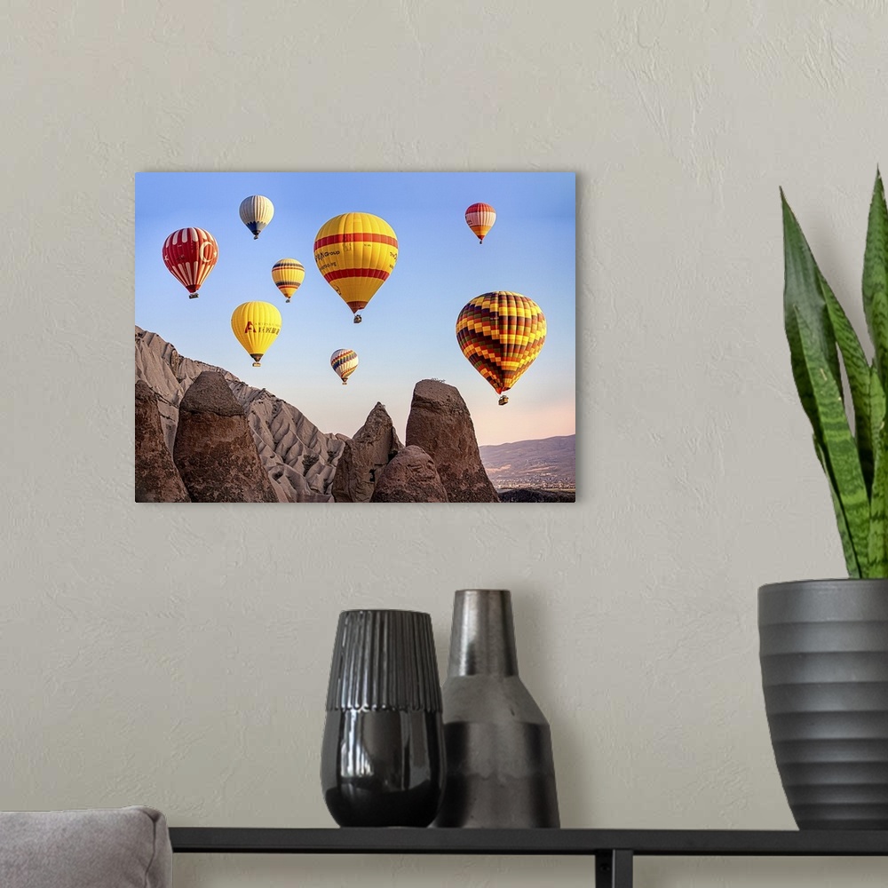 A modern room featuring Large, colorful hot air balloons floating in the sky over Cappadocia, Turkey.