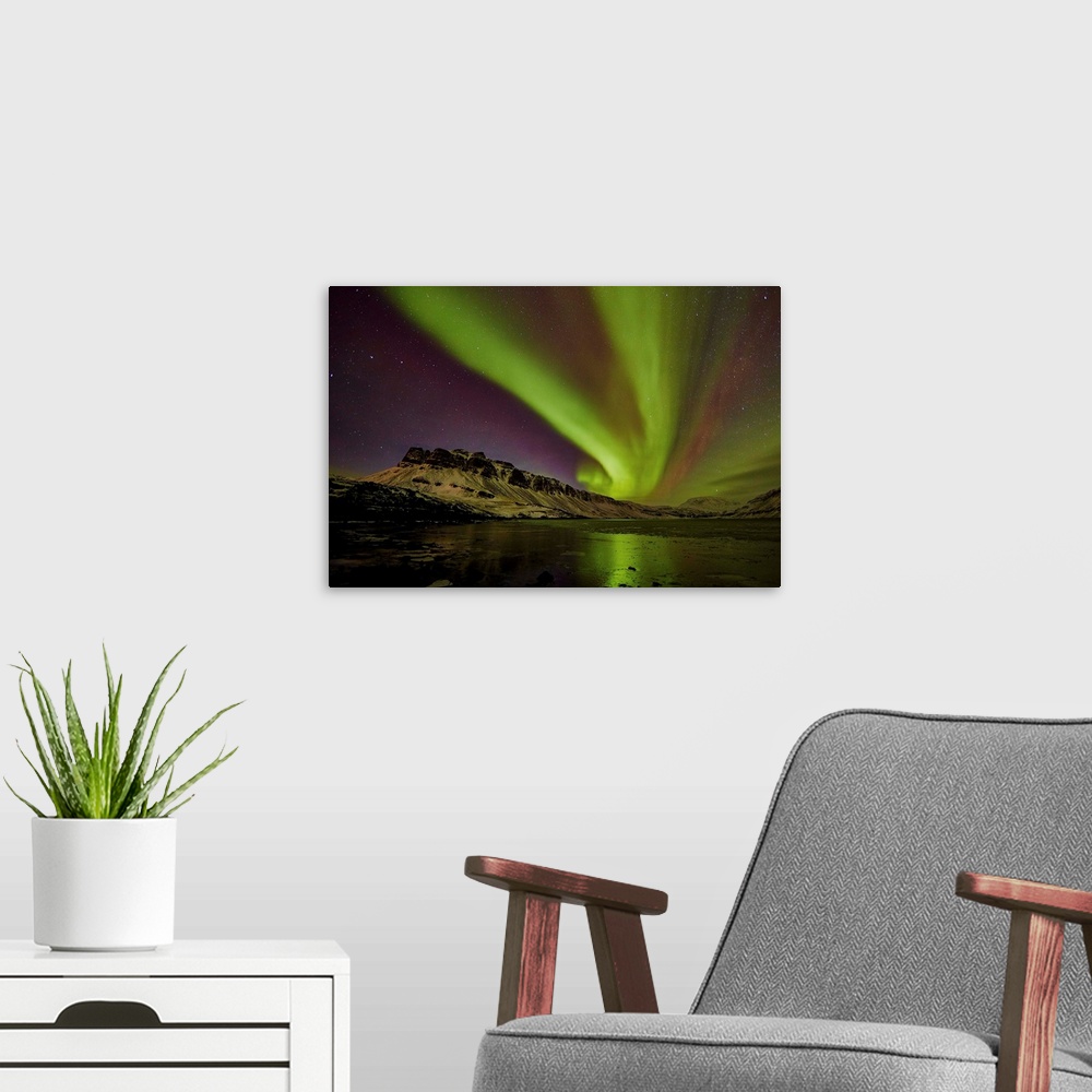 A modern room featuring Aurora borealis in Hvalfordur, West Iceland.