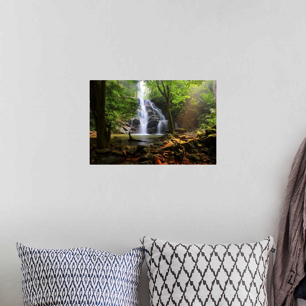 A bohemian room featuring Photograph of a Malaysian forest with a view of a waterfall falling down over top of rocks.