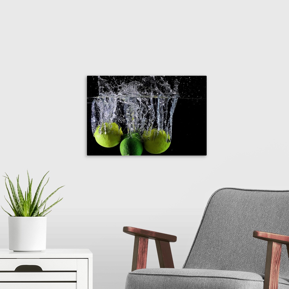 A modern room featuring Lemons and limes splashing into clear water.
