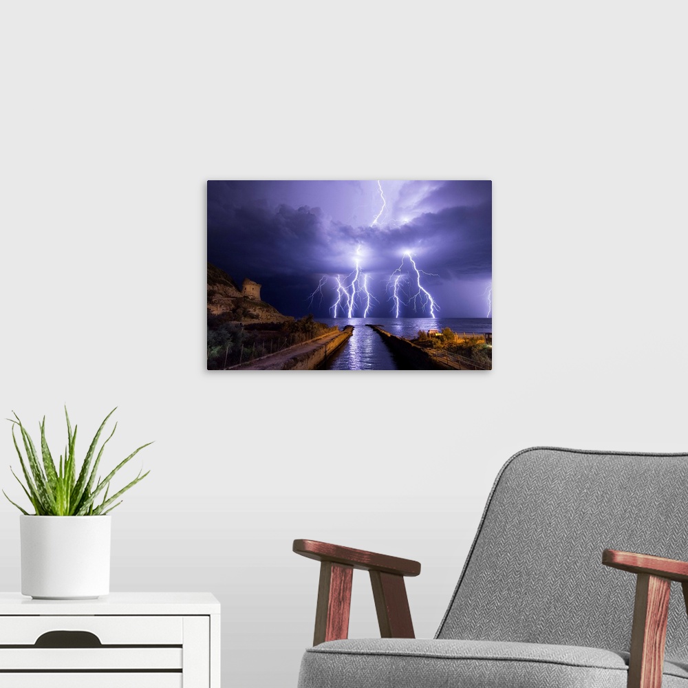 A modern room featuring Lightning storm over the ocean near Torre Paola, Italy.