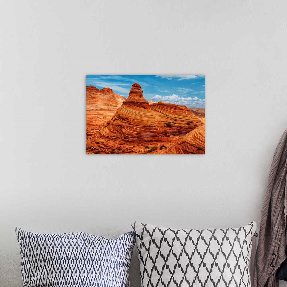 A bohemian room featuring A tall rock formation in the desert in Vermilion Cliffs, Arizona.