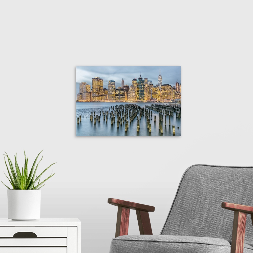 A modern room featuring Manhattan city skyline seen from the harbor in the late afternoon.