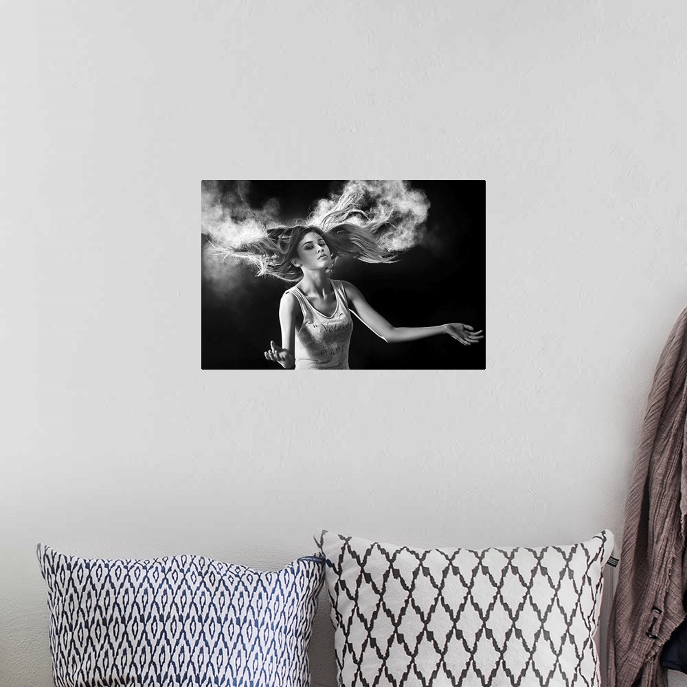 A bohemian room featuring Black and white portrait of a beautiful woman with hair swirling around her.