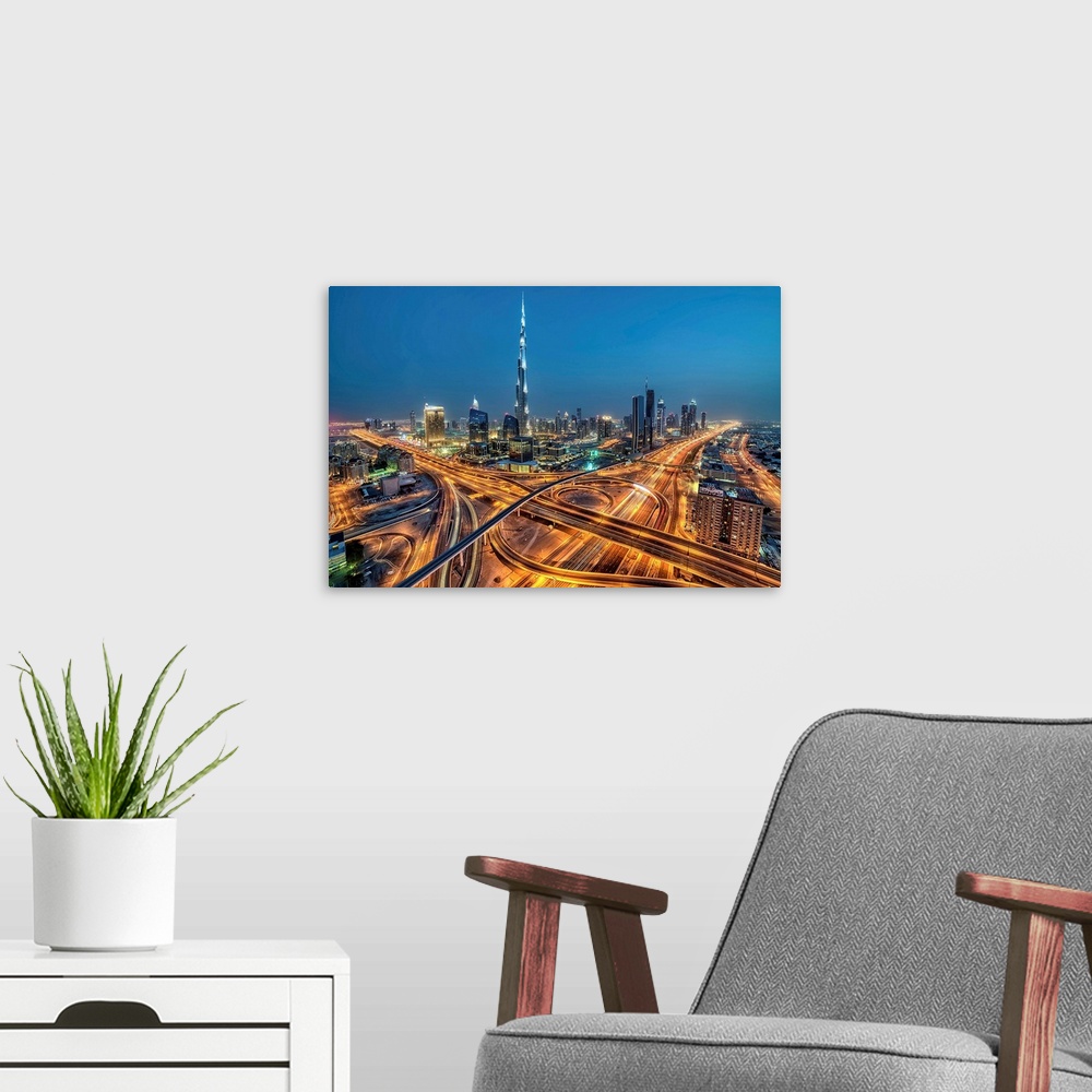 A modern room featuring Aerial view of Downtown Dubai illuminated at night.