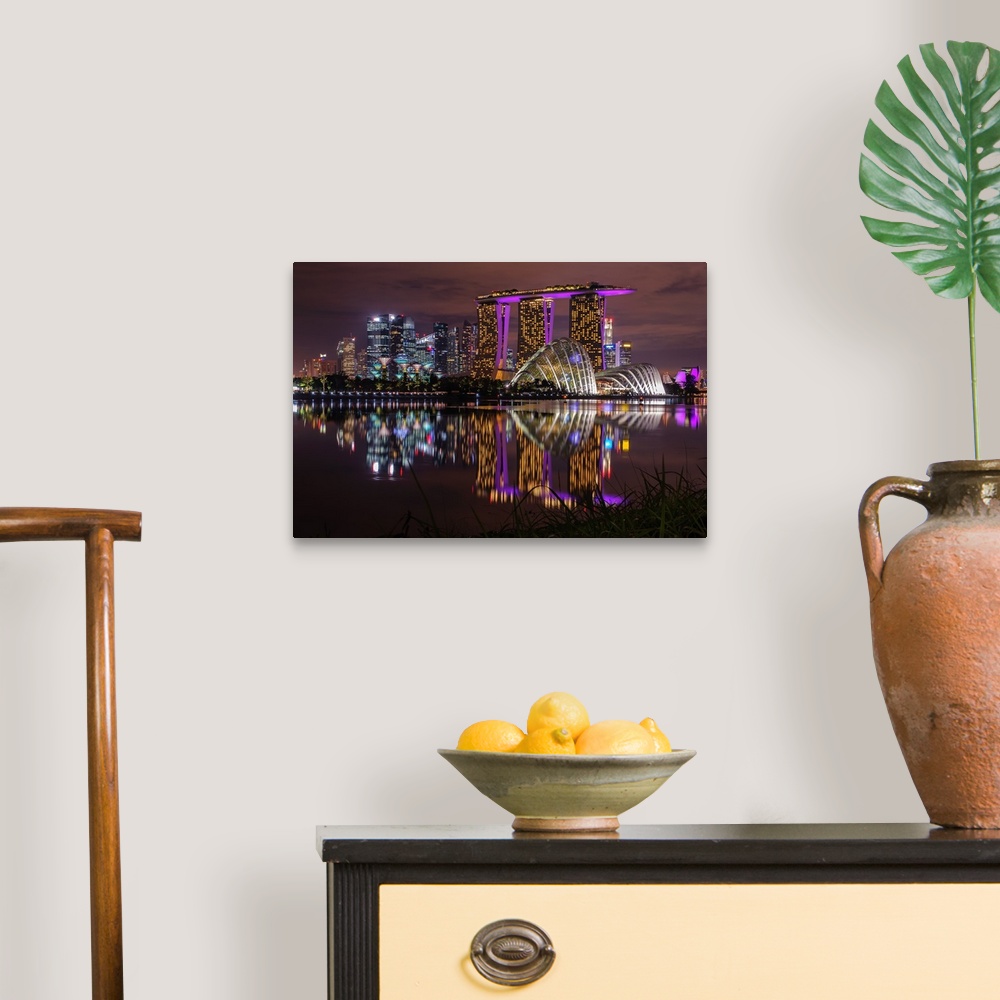 A traditional room featuring Neon lit skyline of Singapore casting reflection in the water below.