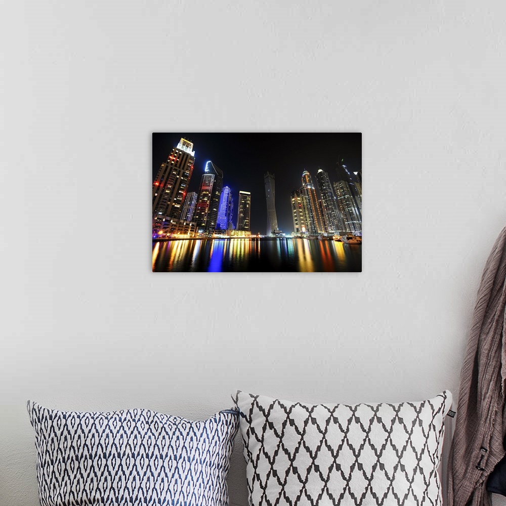 A bohemian room featuring Photograph of a dramatic view of a city skyline lit up in bright lights at night.