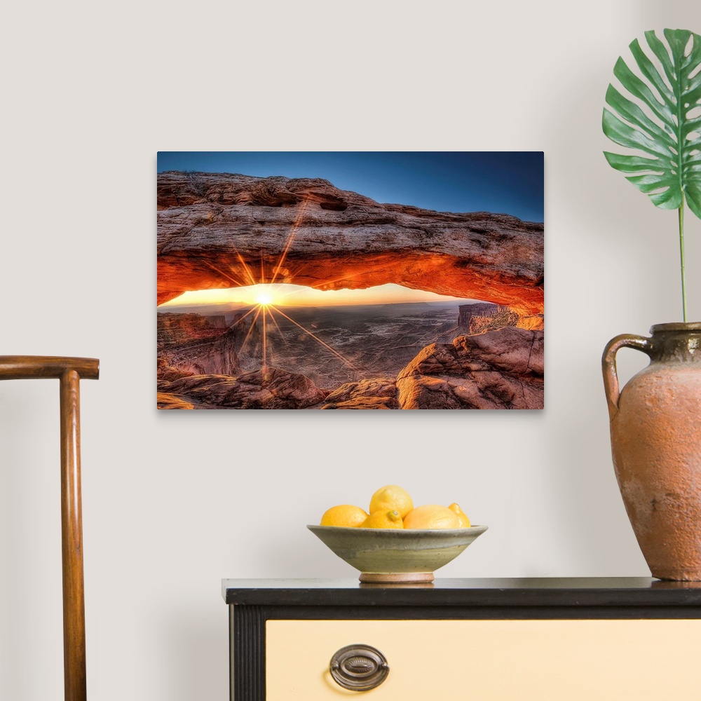 A traditional room featuring The sun rises in Canyonlands National Park and for a brief moment illuminates the breathtaking Me...