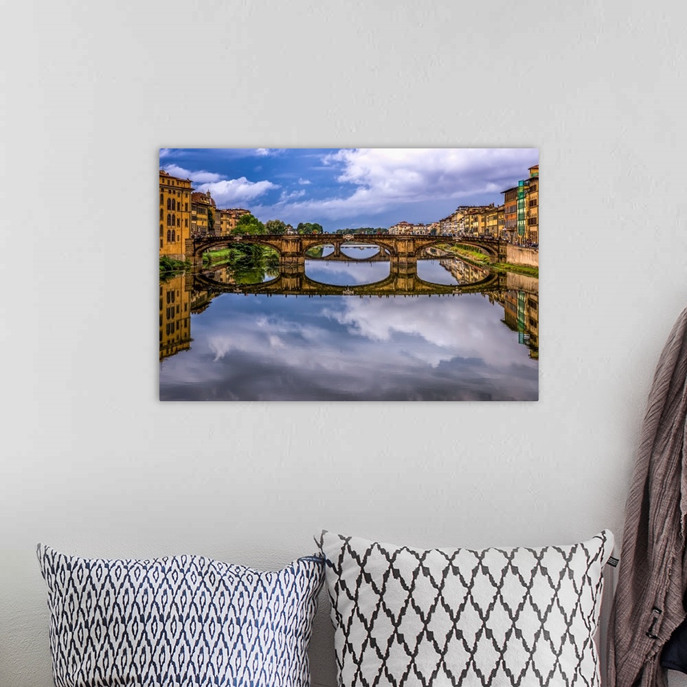 A bohemian room featuring Ponte Vecchio bridge in Florence, Italy, with a mirror reflection in the Arno River.