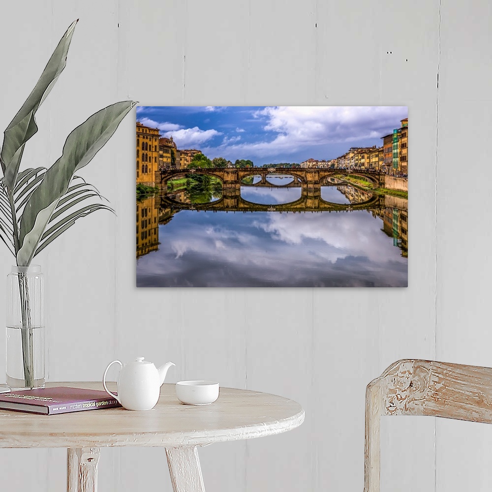 A farmhouse room featuring Ponte Vecchio bridge in Florence, Italy, with a mirror reflection in the Arno River.
