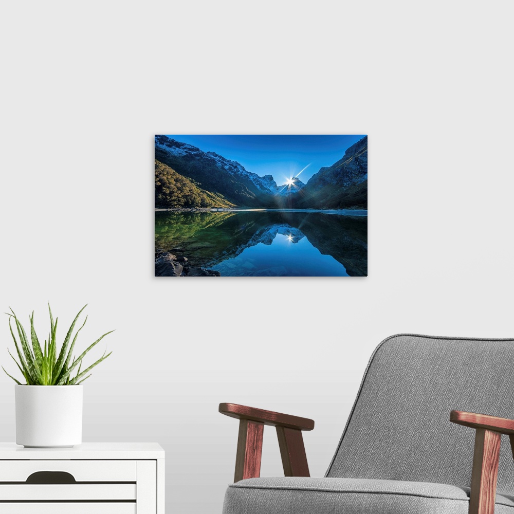 A modern room featuring Mirror reflection of the mountains in the lake water, New Zealand.