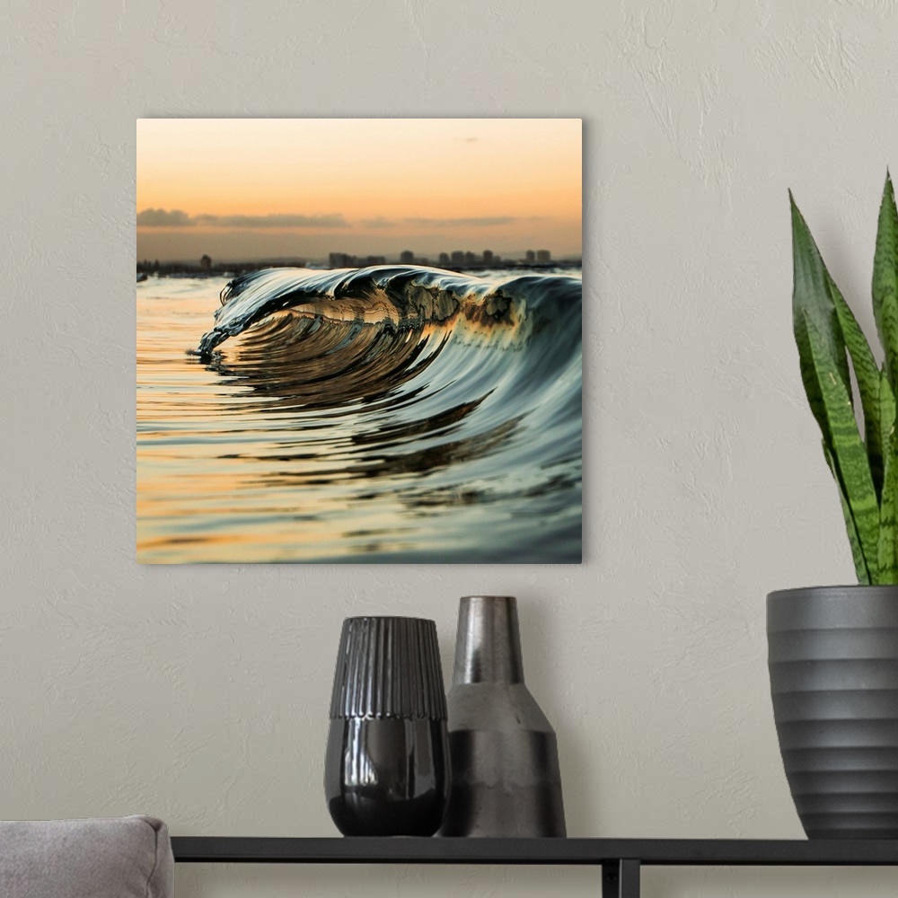 A modern room featuring A "mini" wave off the coast at sunset.
