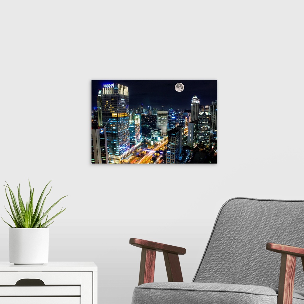 A modern room featuring Moon over the city of Jakarta, Indonesia, at night.