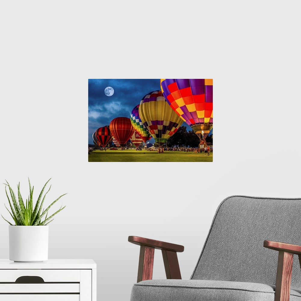 A modern room featuring Moon in the night sky over a row of colorful hot air balloons.