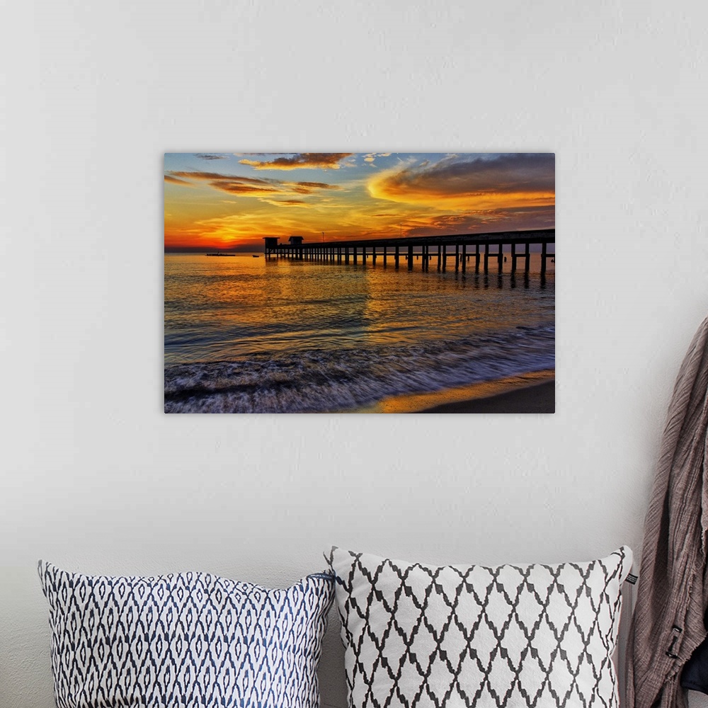 A bohemian room featuring Sunrise over the water from a beach.