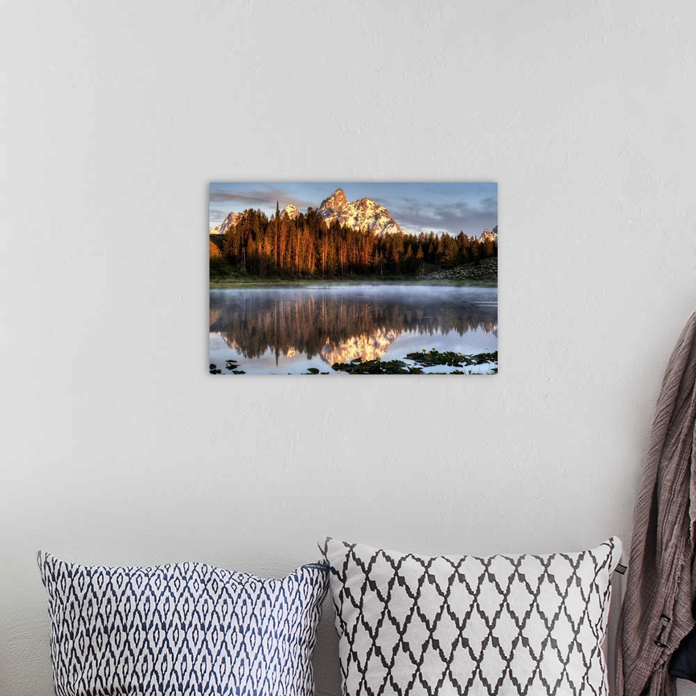 A bohemian room featuring An image of the Grand Tetons at sunrise.