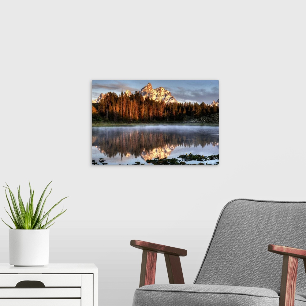 A modern room featuring An image of the Grand Tetons at sunrise.
