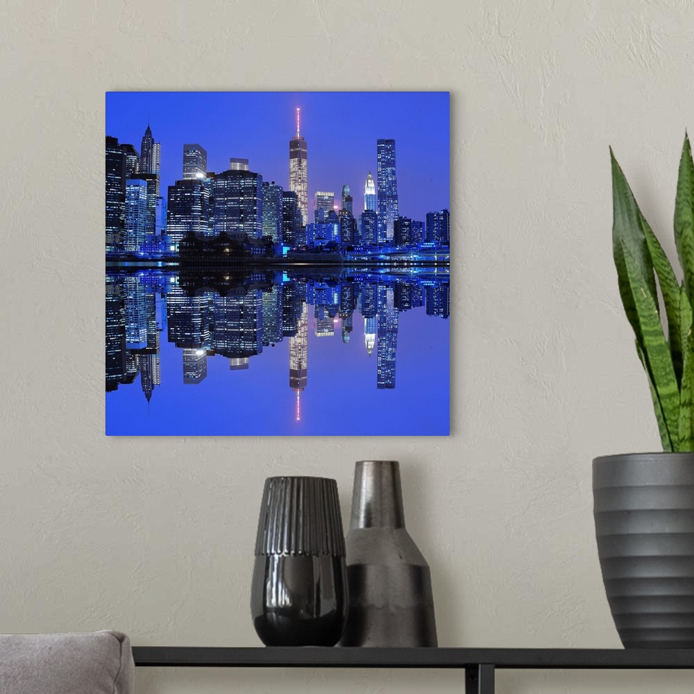 A modern room featuring New York City skyline at night, reflected in the bay below.